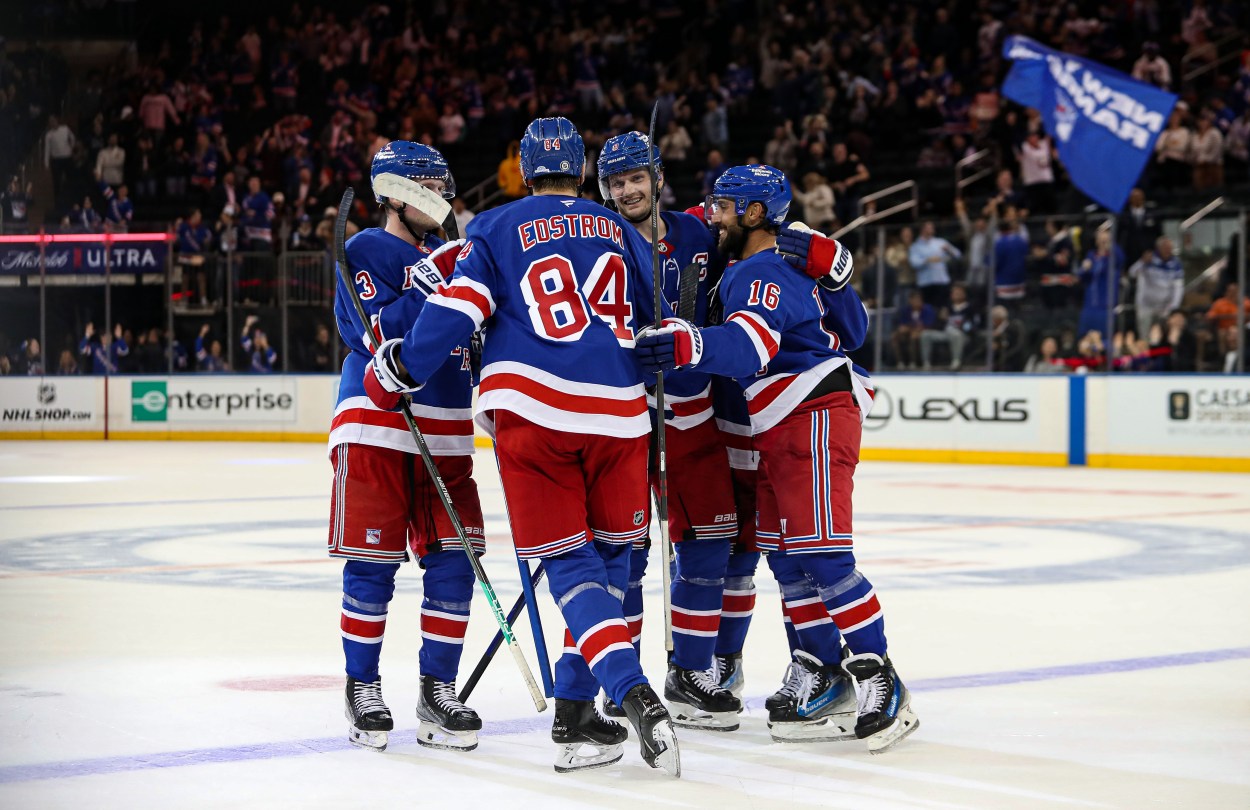 Sep 24, 2024; New York, New York, USA; New York Rangers center Adam Edstrom (84) celebrates game-winner goal with defenseman Jacob Trouba (8) and center Vincent Trocheck (16) during the third period against the New York Islanders at Madison Square Garden. Mandatory Credit: Danny Wild-Imagn Images