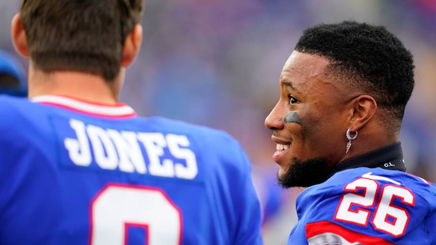 New York Giants running back Saquon Barkley (26) and quarterback Daniel Jones (8) talk on the sideline as the fourth quarter ends during the Giants win over the Chicago Bears at MetLife Stadium on Sunday, Oct. 2, 2022, in East Rutherford.