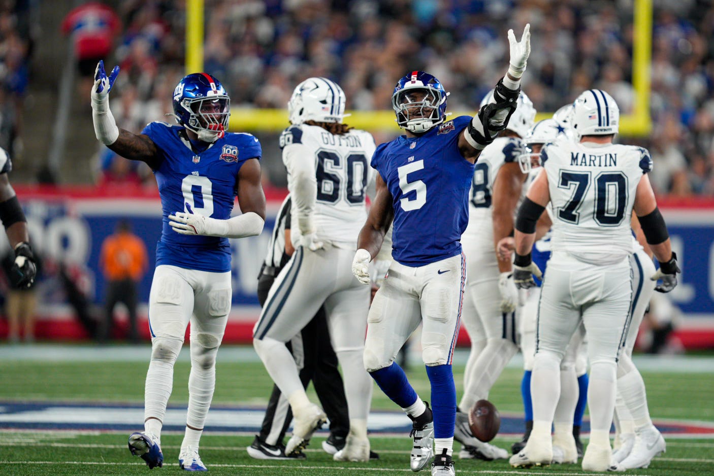 Sep 26, 2024; East Rutherford, NJ, US; New York Giants linebacker Brian Burns (0) and New York Giants linebacker Kayvon Thibodeaux (5) celebrate after sacking Dallas Cowboys quarterback Dak Prescott (4) at MetLife Stadium. Mandatory Credit: Julian Guadalupe-NorthJersey.com