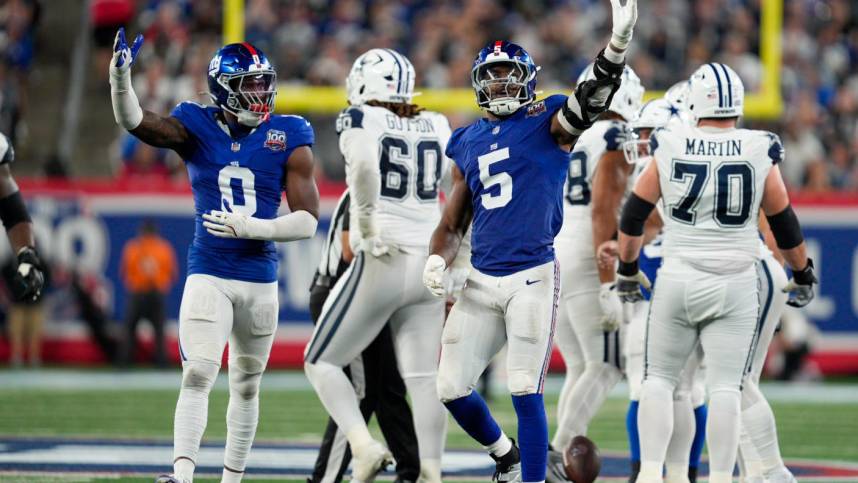 Sep 26, 2024; East Rutherford, NJ, US; New York Giants linebacker Brian Burns (0) and New York Giants linebacker Kayvon Thibodeaux (5) celebrate after sacking Dallas Cowboys quarterback Dak Prescott (4) at MetLife Stadium. Mandatory Credit: Julian Guadalupe-NorthJersey.com