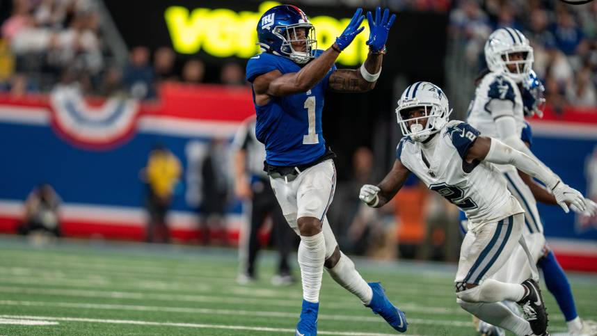 Sep 26, 2024; East Rutherford, NJ, US; New York Giants wide receiver Malik Nabers (1) catches a pass in the fourth quarter before being tackled by Dallas Cowboys cornerback Jourdan Lewis (2) at MetLife Stadium. Mandatory Credit: Julian Guadalupe-NorthJersey.com