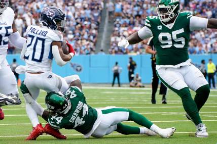 Tennessee Titans running back Tony Pollard (20) is tackled by New York Jets linebacker Jamien Sherwood (44) during the second quarter at Nissan Stadium in Nashville, Tenn., Sunday, Sept. 15, 2024.