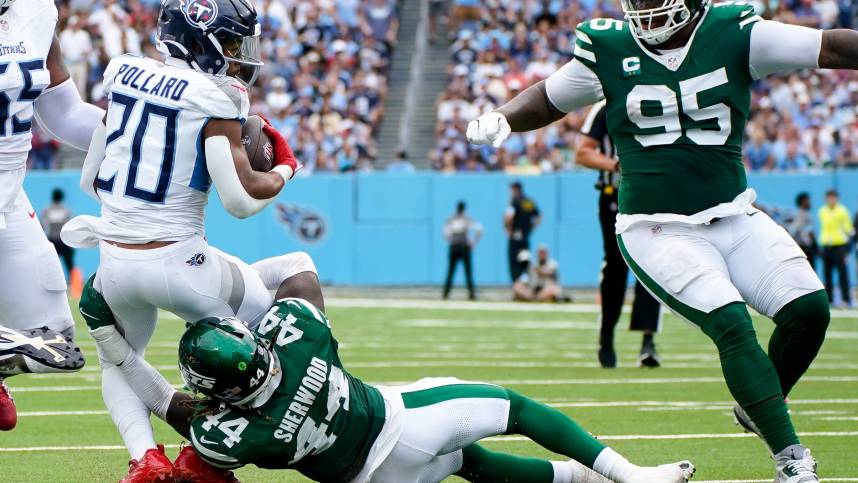 Tennessee Titans running back Tony Pollard (20) is tackled by New York Jets linebacker Jamien Sherwood (44) during the second quarter at Nissan Stadium in Nashville, Tenn., Sunday, Sept. 15, 2024.