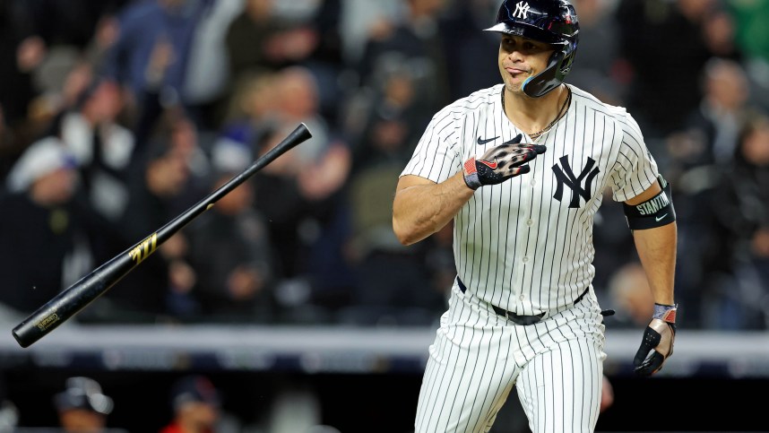 Oct 14, 2024; Bronx, New York, USA; New York Yankees designated hitter Giancarlo Stanton (27) hits a solo home run during the seventh inning against the Cleveland Guardians in game one of the ALCS for the 2024 MLB Playoffs at Yankee Stadium. Mandatory Credit: Brad Penner-Imagn Images