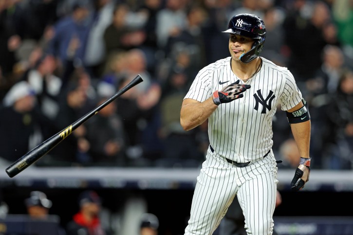 Oct 14, 2024; Bronx, New York, USA; New York Yankees designated hitter Giancarlo Stanton (27) hits a solo home run during the seventh inning against the Cleveland Guardians in game one of the ALCS for the 2024 MLB Playoffs at Yankee Stadium. Mandatory Credit: Brad Penner-Imagn Images