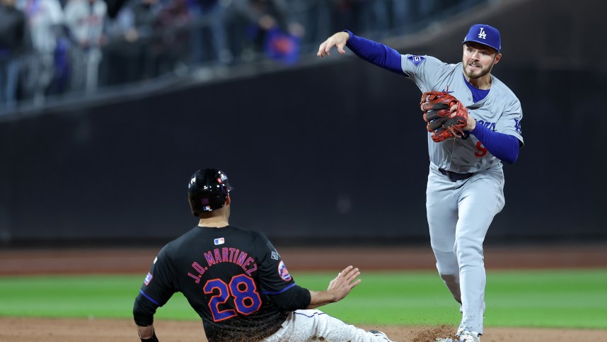 Oct 16, 2024; New York City, New York, USA; Los Angeles Dodgers second base Gavin Lux (9) gets a double play against New York Mets designated hitter J.D. Martinez (28) in the seventh inning during game three of the NLCS for the 2024 MLB playoffs at Citi Field. Mandatory Credit: Brad Penner-Imagn Images