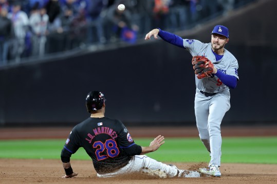 Oct 16, 2024; New York City, New York, USA; Los Angeles Dodgers second base Gavin Lux (9) gets a double play against New York Mets designated hitter J.D. Martinez (28) in the seventh inning during game three of the NLCS for the 2024 MLB playoffs at Citi Field. Mandatory Credit: Brad Penner-Imagn Images