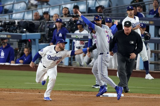 Oct 13, 2024; Los Angeles, California, USA; Los Angeles Dodgers third base Max Muncy (13) makes the tag for an out against New York Mets outfielder Jesse Winker (3) in the fourth inning during game one of the NLCS for the 2024 MLB Playoffs at Dodger Stadium. Mandatory Credit: Jason Parkhurst-Imagn Images