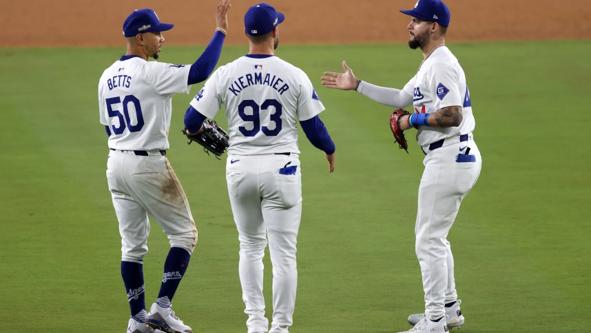 Oct 13, 2024; Los Angeles, California, USA; Los Angeles Dodgers shortstop Mookie Betts (50) reacts with outfielder Andy Pages (44) and outfielder Kevin Kiermaier (93)  teammates after the ninth inning during game one of the NLCS for the 2024 MLB Playoffs at Dodger Stadium.  Mandatory Credit: Jason Parkhurst-Imagn Images