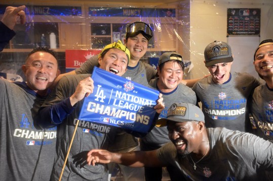 Oct 20, 2024; Los Angeles, California, USA; Los Angeles Dodgers pitcher Yoshinobu Yamamoto (18) and designated hitter Shohei Ohtani (17) celebrate in the clubhouse after defeating the New York Mets in game six of the NLCS for the 2024 MLB playoffs at Dodger Stadium. Mandatory Credit: Jayne Kamin-Oncea-Imagn Images