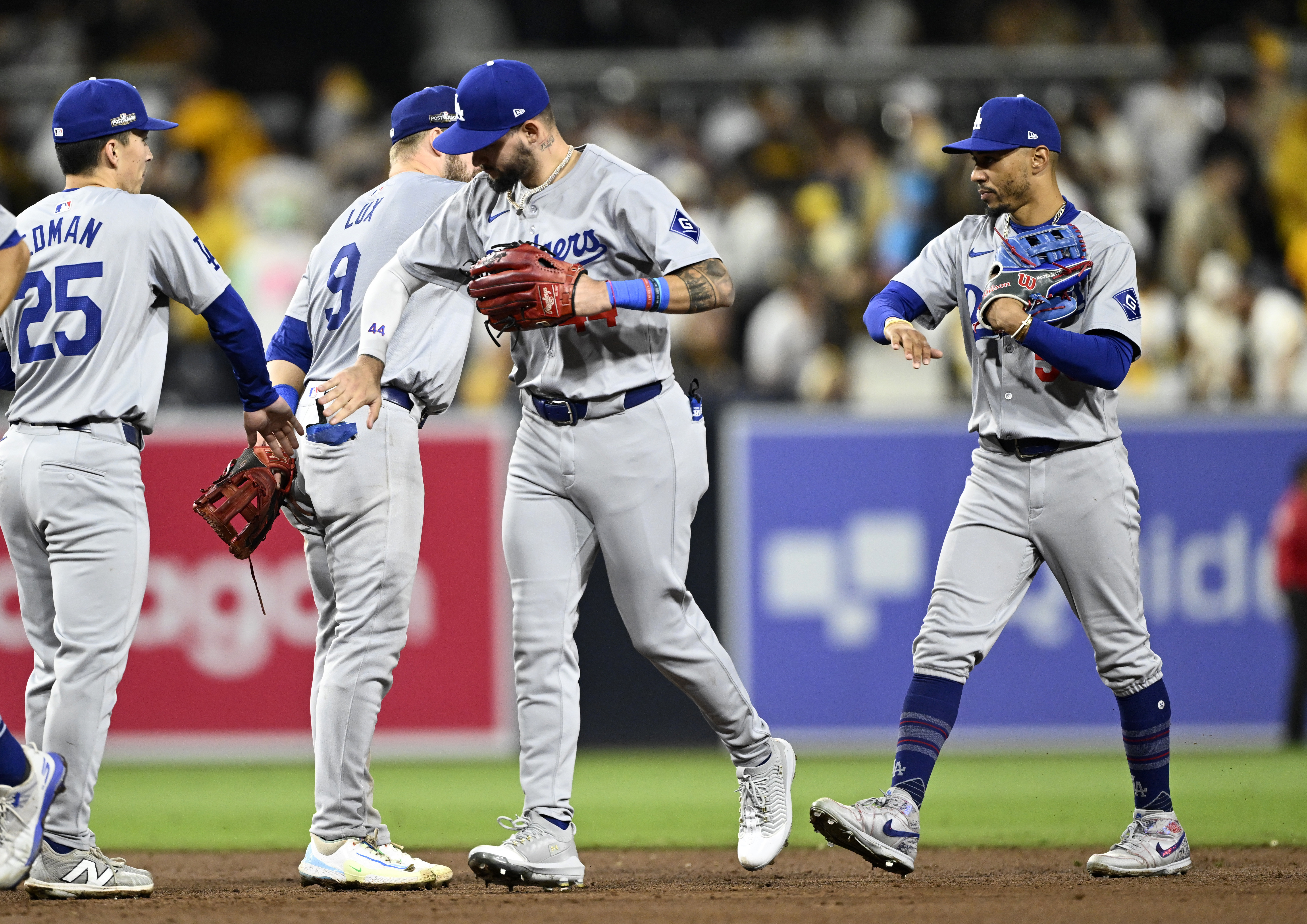 Oct 9, 2024; San Diego, California, USA; Los Angeles Dodgers outfielder Andy Pages (44) and shortstop Mookie Betts (50) celebrate with teammates after winning game four of the NLDS for the 2024 MLB Playoffs against the San Diego Padres at Petco Park.  Mandatory Credit: Denis Poroy-Imagn Images