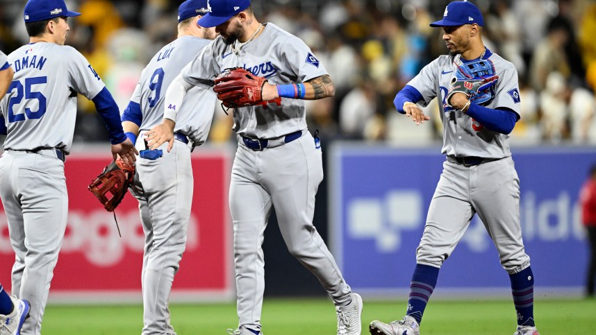 Oct 9, 2024; San Diego, California, USA; Los Angeles Dodgers outfielder Andy Pages (44) and shortstop Mookie Betts (50) celebrate with teammates after winning game four of the NLDS for the 2024 MLB Playoffs against the San Diego Padres at Petco Park.  Mandatory Credit: Denis Poroy-Imagn Images