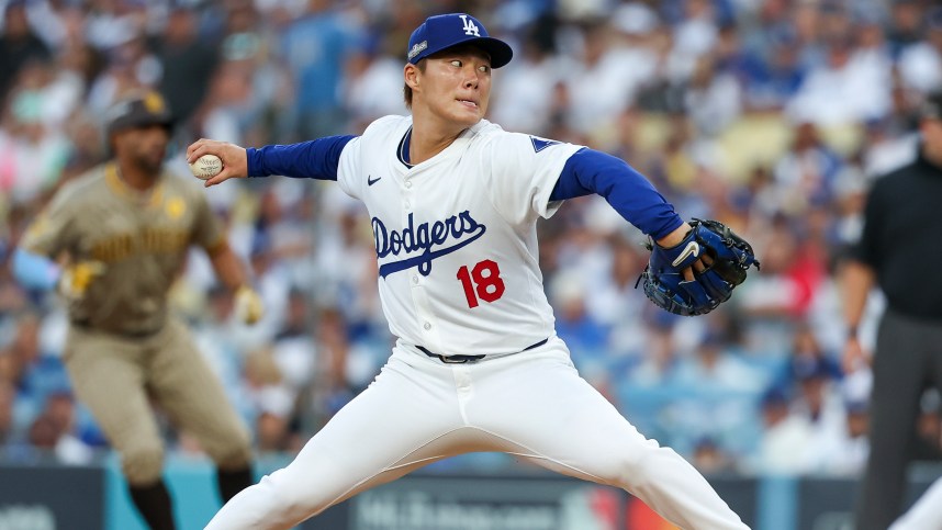 Oct 5, 2024; Los Angeles, California, USA; Los Angeles pitcher Yoshinobu Yamamoto (18) throws a pitch in the first inning against the San Diego Padres during game one of the NLDS for the 2024 MLB Playoffs at Dodger Stadium. Mandatory Credit: Kiyoshi Mio-Imagn Images