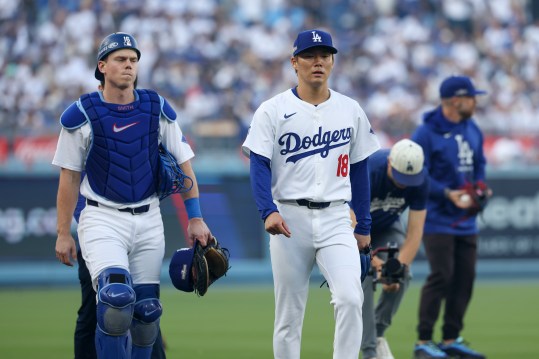 Oct 5, 2024; Los Angeles, California, USA; Los Angeles Dodgers catcher Will Smith (16) and pitcher Yoshinobu Yamamoto (18) head to the dugout before playing the San Diego Padres during game one of the NLDS for the 2024 MLB Playoffs at Dodger Stadium. Mandatory Credit: Kiyoshi Mio-Imagn Images