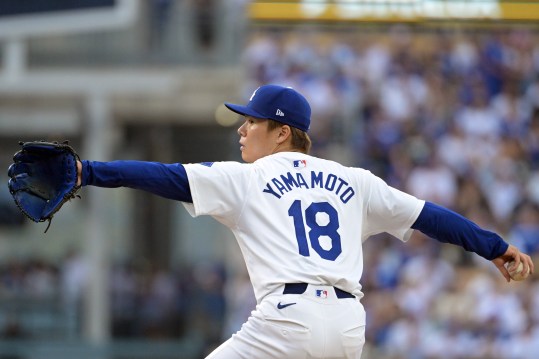 Oct 11, 2024; Los Angeles, California, USA; Los Angeles Dodgers pitcher Yoshinobu Yamamoto (18) pitches against the San Diego Padres in the second inning during game five of the NLDS for the 2024 MLB Playoffs at Dodger Stadium. Mandatory Credit: Jayne Kamin-Oncea-Imagn Images