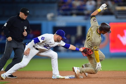 Sep 24, 2024; Los Angeles, California, USA; San Diego Padres catcher Kyle Higashioka (20) steals second against Los Angeles Dodgers second baseman Gavin Lux (9) during the seventh inning at Dodger Stadium. Mandatory Credit: Gary A. Vasquez-Imagn Images