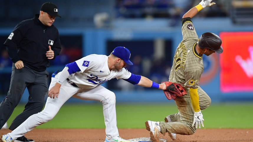 Sep 24, 2024; Los Angeles, California, USA; San Diego Padres catcher Kyle Higashioka (20) steals second against Los Angeles Dodgers second baseman Gavin Lux (9) during the seventh inning at Dodger Stadium. Mandatory Credit: Gary A. Vasquez-Imagn Images