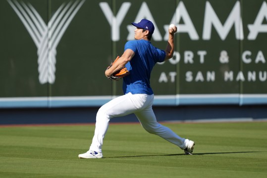 Sep 25, 2024; Los Angeles, California, USA; Los Angeles Dodgers designated hitter Shohei Ohtani throws before the game against the San Diego Padres at Dodger Stadium. Mandatory Credit: Kirby Lee-Imagn Images