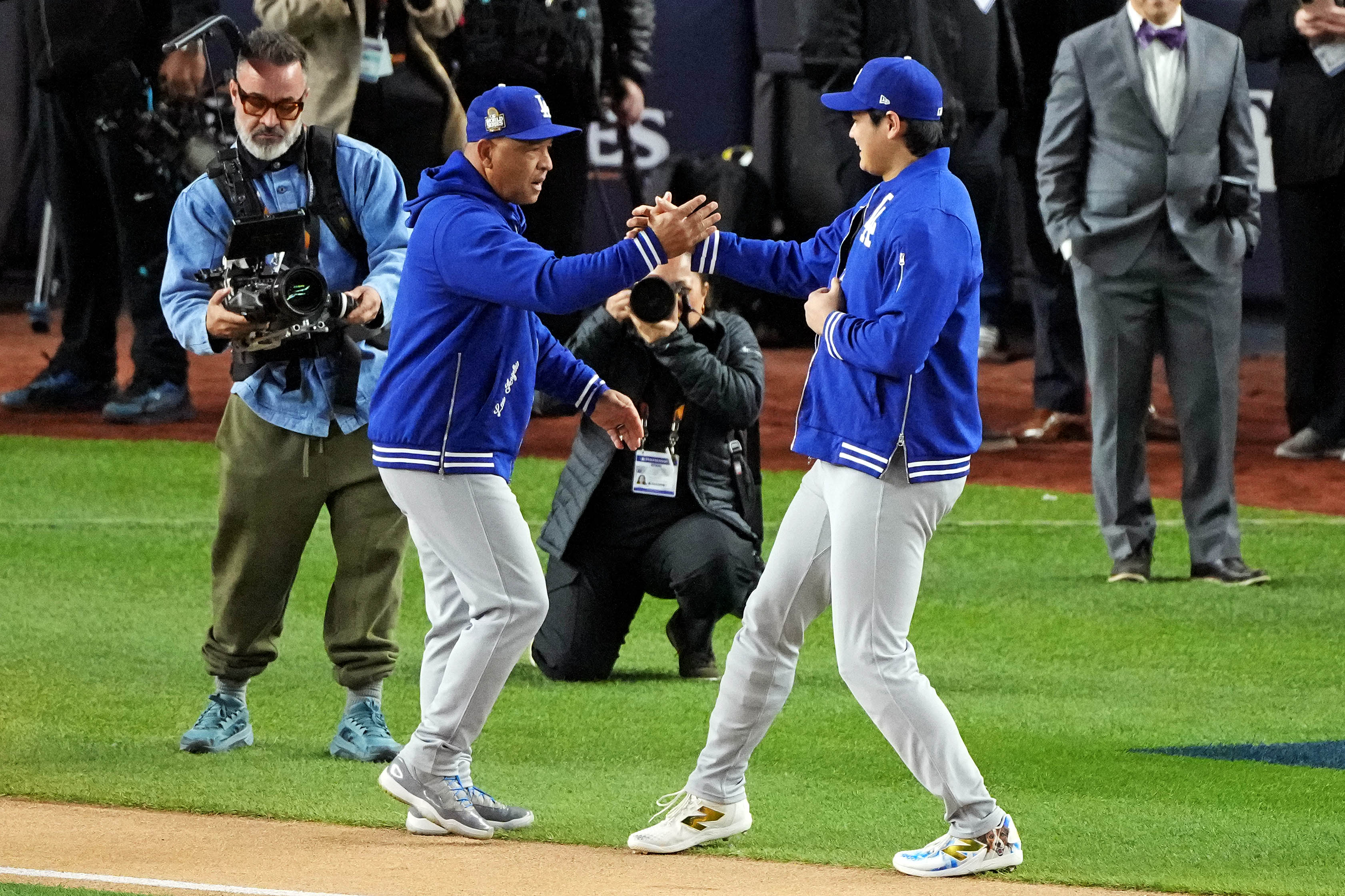 Oct 28, 2024; New York, New York, USA; Los Angeles Dodgers manager Dave Roberts (30) greets two-way player Shohei Ohtani (17) during player introductions before playing against the New York Yankees in game three of the 2024 MLB World Series at Yankee Stadium. Mandatory Credit: Robert Deutsch-Imagn Images