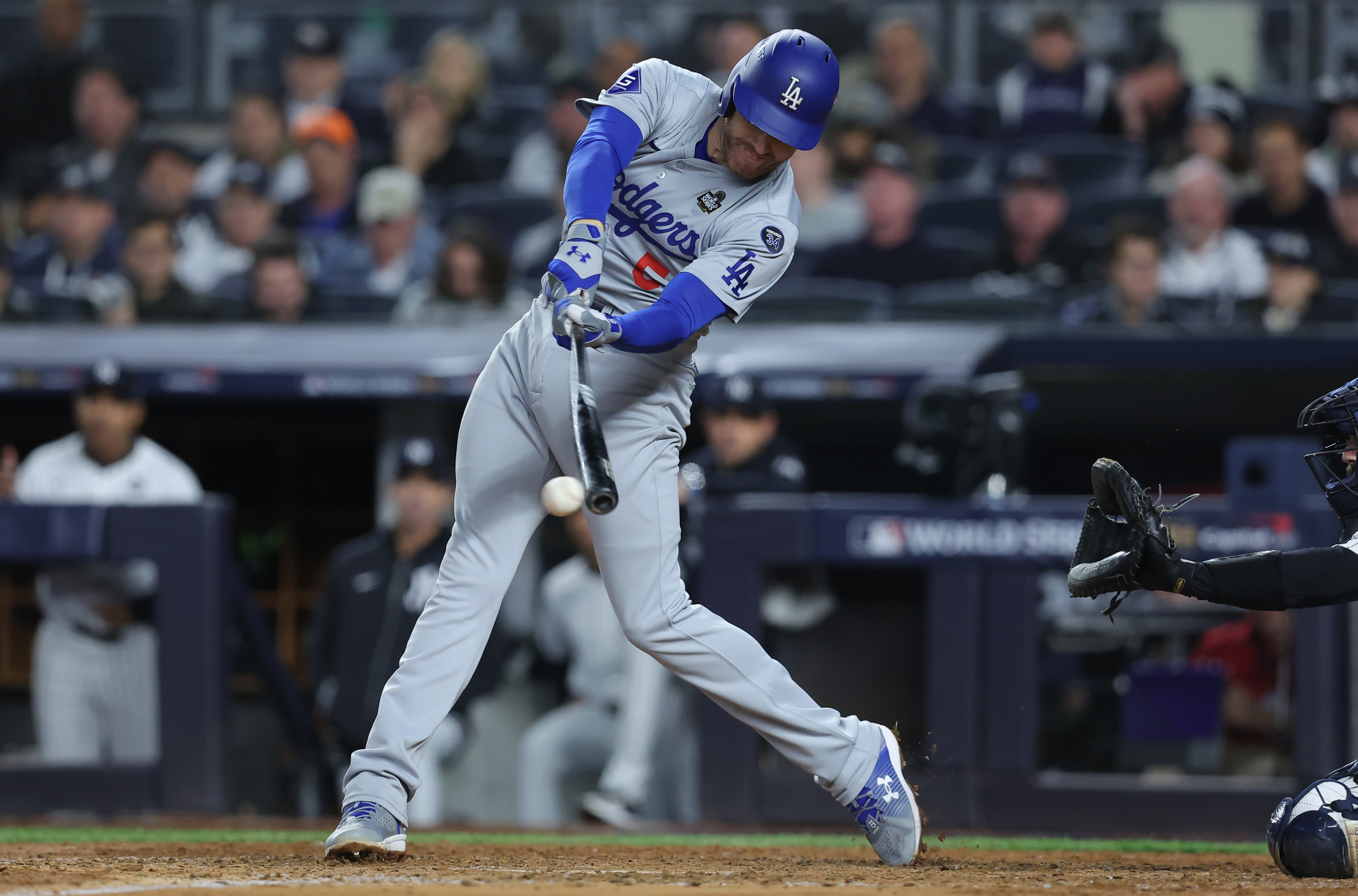 Oct 29, 2024; New York, New York, USA; Los Angeles Dodgers first baseman Freddie Freeman (5) hits a RBI fielders choice during the fifth inning against the New York Yankees in game four of the 2024 MLB World Series at Yankee Stadium. Mandatory Credit: Brad Penner-Imagn Images