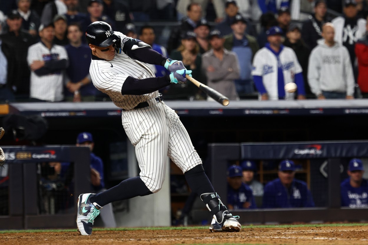 Oct 29, 2024; Bronx, New York, USA; New York Yankees outfielder Aaron Judge (99) hits a single against the Los Angeles Dodgers in the eighth inning during game four of the 2024 MLB World Series at Yankee Stadium. Mandatory Credit: Robert Deutsch-Imagn Images