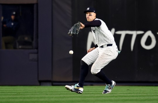 Oct 30, 2024; New York, New York, USA; New York Yankees outfielder Aaron Judge (99) makes a fielding error during the fifth inning against the Los Angeles Dodgers in game five of the 2024 MLB World Series at Yankee Stadium. Mandatory Credit: Vincent Carchietta-Imagn Images