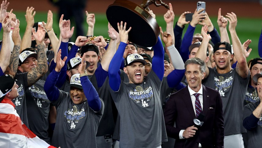 Oct 31, 2024; New York, New York, USA; Los Angeles Dodgers first baseman Freddie Freeman (5) accepts the Willie Mays World Series Most Valuable Player trophy after winning the 2024 MLB World Series against the New York Yankees at Yankee Stadium. Mandatory Credit: Vincent Carchietta-Imagn Images