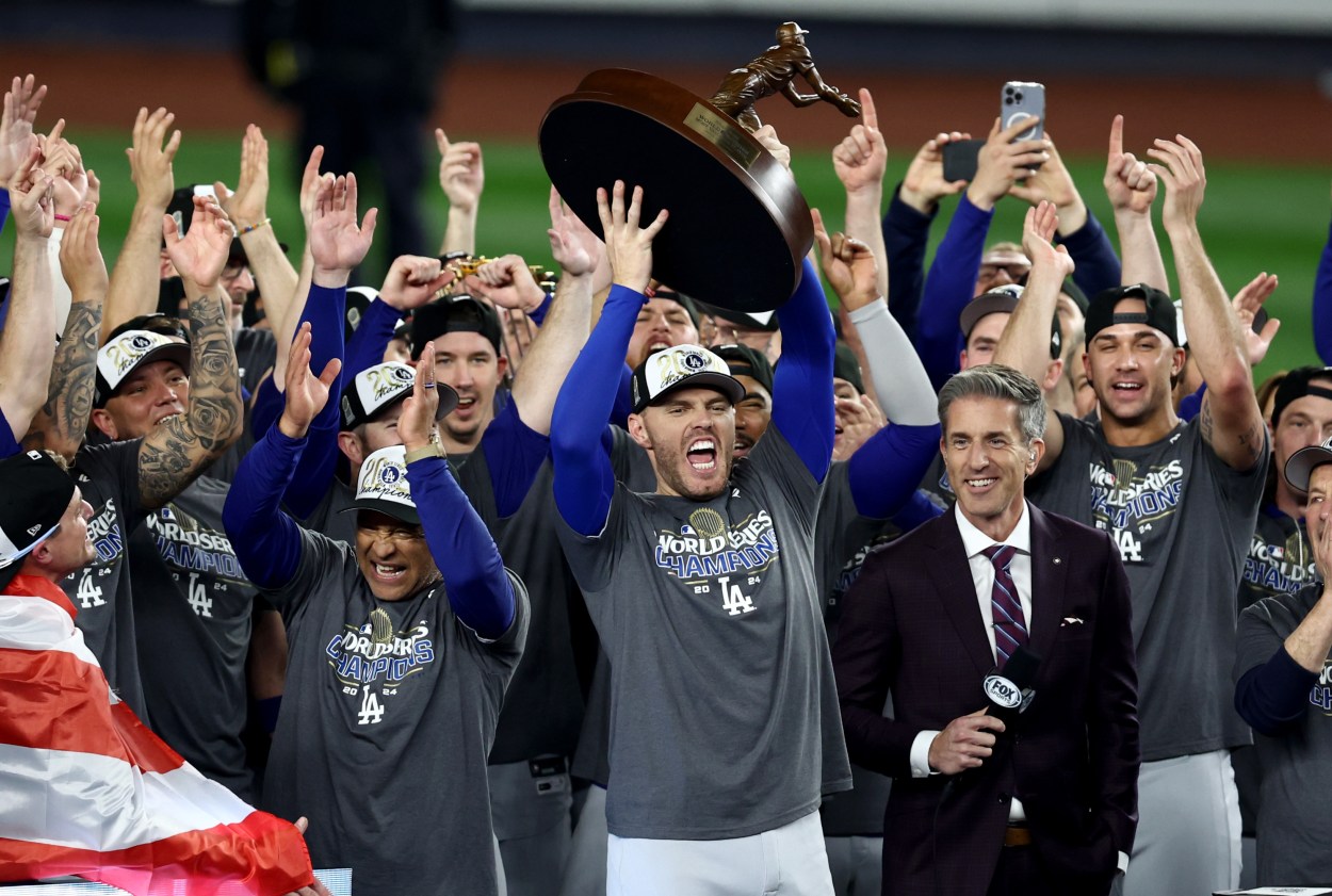 Oct 31, 2024; New York, New York, USA; Los Angeles Dodgers first baseman Freddie Freeman (5) accepts the Willie Mays World Series Most Valuable Player trophy after winning the 2024 MLB World Series against the New York Yankees at Yankee Stadium. Mandatory Credit: Vincent Carchietta-Imagn Images