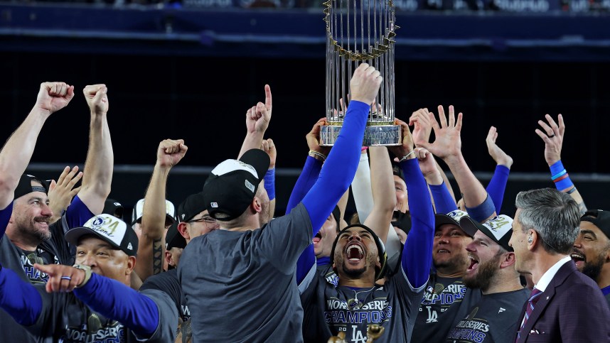 Oct 31, 2024; New York, New York, USA; Los Angeles Dodgers first baseman Freddie Freeman (5) celebrates with the Commissioner’s Trophy after the Los Angeles Dodgers beat the New York Yankees in game four to win the 2024 MLB World Series at Yankee Stadium. Mandatory Credit: Brad Penner-Imagn Images