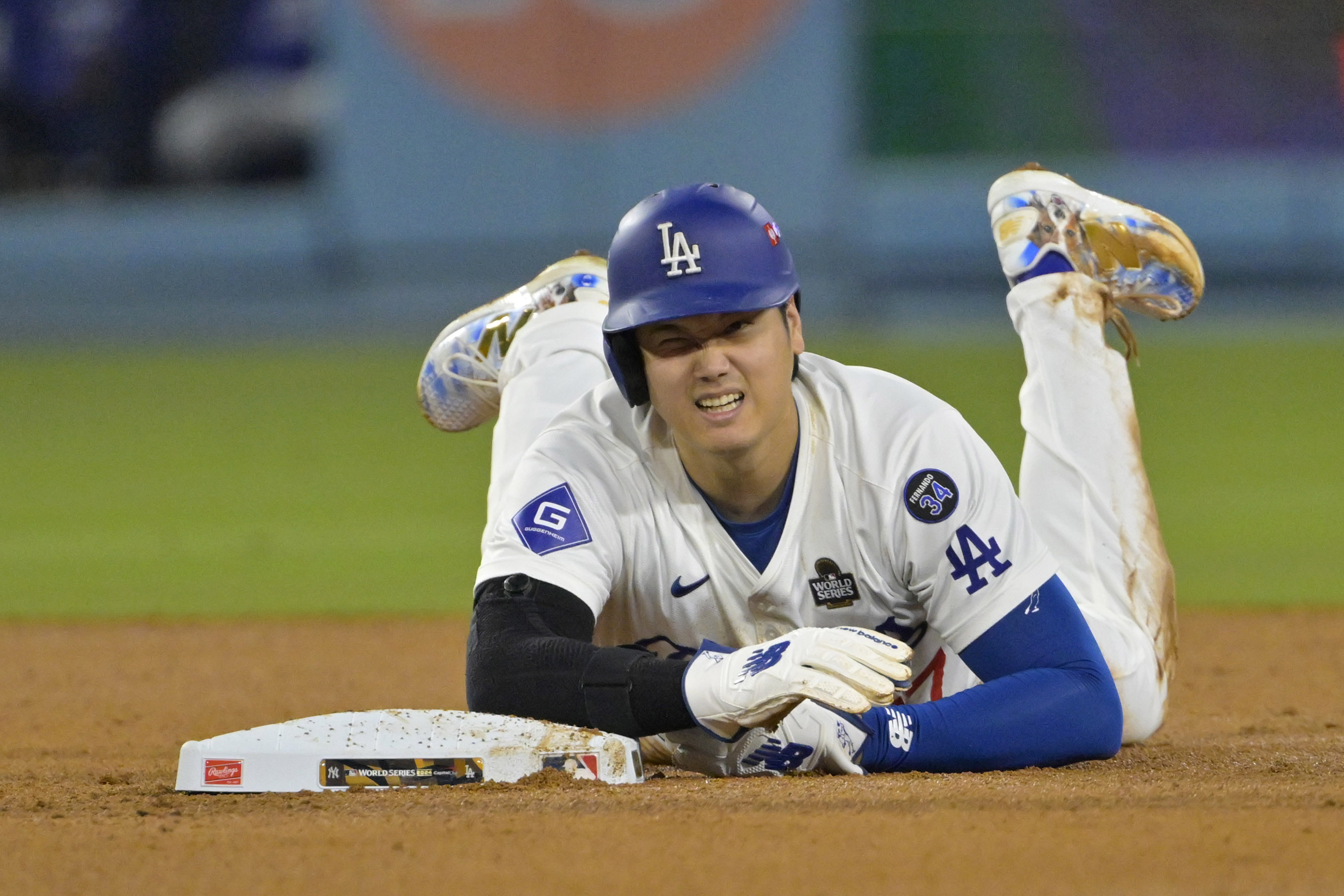 Oct 26, 2024; Los Angeles, California, USA; Los Angeles Dodgers designated hitter Shohei Ohtani (17) reacts at second base after an apparent injury in the seventh inning against the New York Yankees during game two of the 2024 MLB World Series at Dodger Stadium. Mandatory Credit: Jayne Kamin-Oncea-Imagn Images