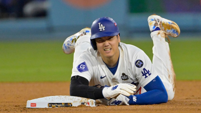 Oct 26, 2024; Los Angeles, California, USA; Los Angeles Dodgers designated hitter Shohei Ohtani (17) reacts at second base after an apparent injury in the seventh inning against the New York Yankees during game two of the 2024 MLB World Series at Dodger Stadium. Mandatory Credit: Jayne Kamin-Oncea-Imagn Images