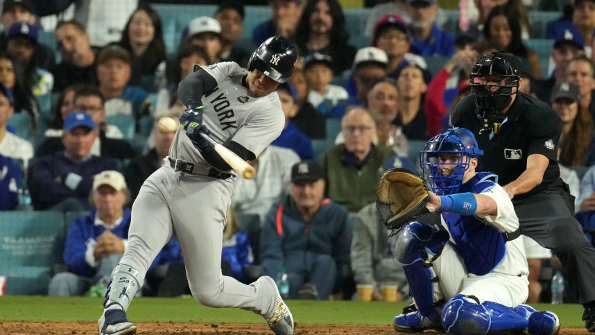 Oct 26, 2024; Los Angeles, California, USA; New York Yankees outfielder Juan Soto (22) hits a single against the Los Angeles Dodgers in the ninth inning for game two of the 2024 MLB World Series at Dodger Stadium. Mandatory Credit: Kirby Lee-Imagn Images