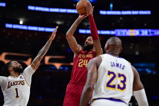 Apr 6, 2024; Los Angeles, California, USA; Cleveland Cavaliers forward Marcus Morris Sr. (24) shoots against Los Angeles Lakers guard D'Angelo Russell (1) and forward LeBron James (23) during the first half at Crypto.com Arena. Mandatory Credit: Gary A. Vasquez-Imagn Images