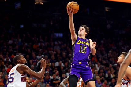 Oct 28, 2024; Phoenix, Arizona, USA; Los Angeles Lakers guard Austin Reaves (15) shoots the ball against Phoenix Suns forward Kevin Durant (35) during the first quarter at Footprint Center. Mandatory Credit: Mark J. Rebilas-Imagn Images