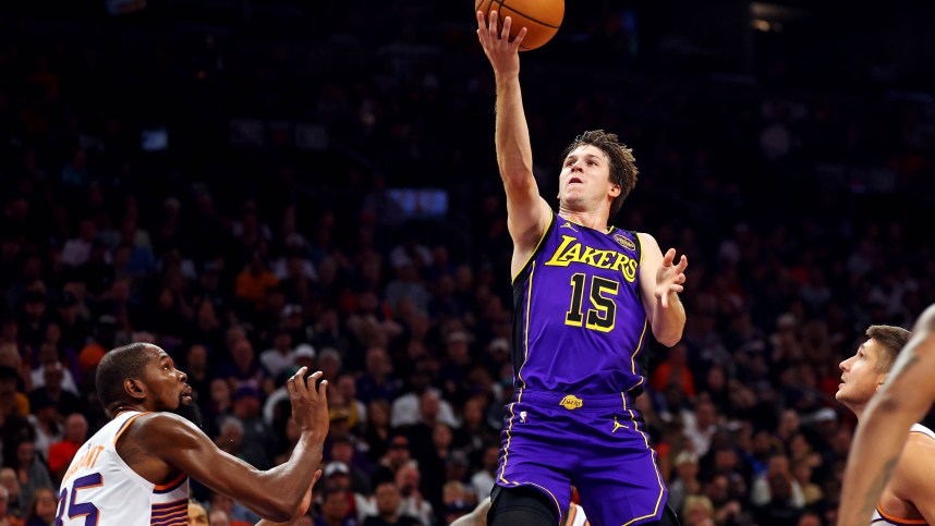 Oct 28, 2024; Phoenix, Arizona, USA; Los Angeles Lakers guard Austin Reaves (15) shoots the ball against Phoenix Suns forward Kevin Durant (35) during the first quarter at Footprint Center. Mandatory Credit: Mark J. Rebilas-Imagn Images