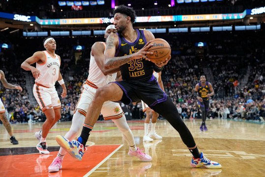 Dec 15, 2023; San Antonio, Texas, USA; Los Angeles Lakers forward Christian Wood (35) drives to the basket while defended by San Antonio Spurs guard Malaki Branham (22) during the second half at Frost Bank Center. Mandatory Credit: Scott Wachter-Imagn Images