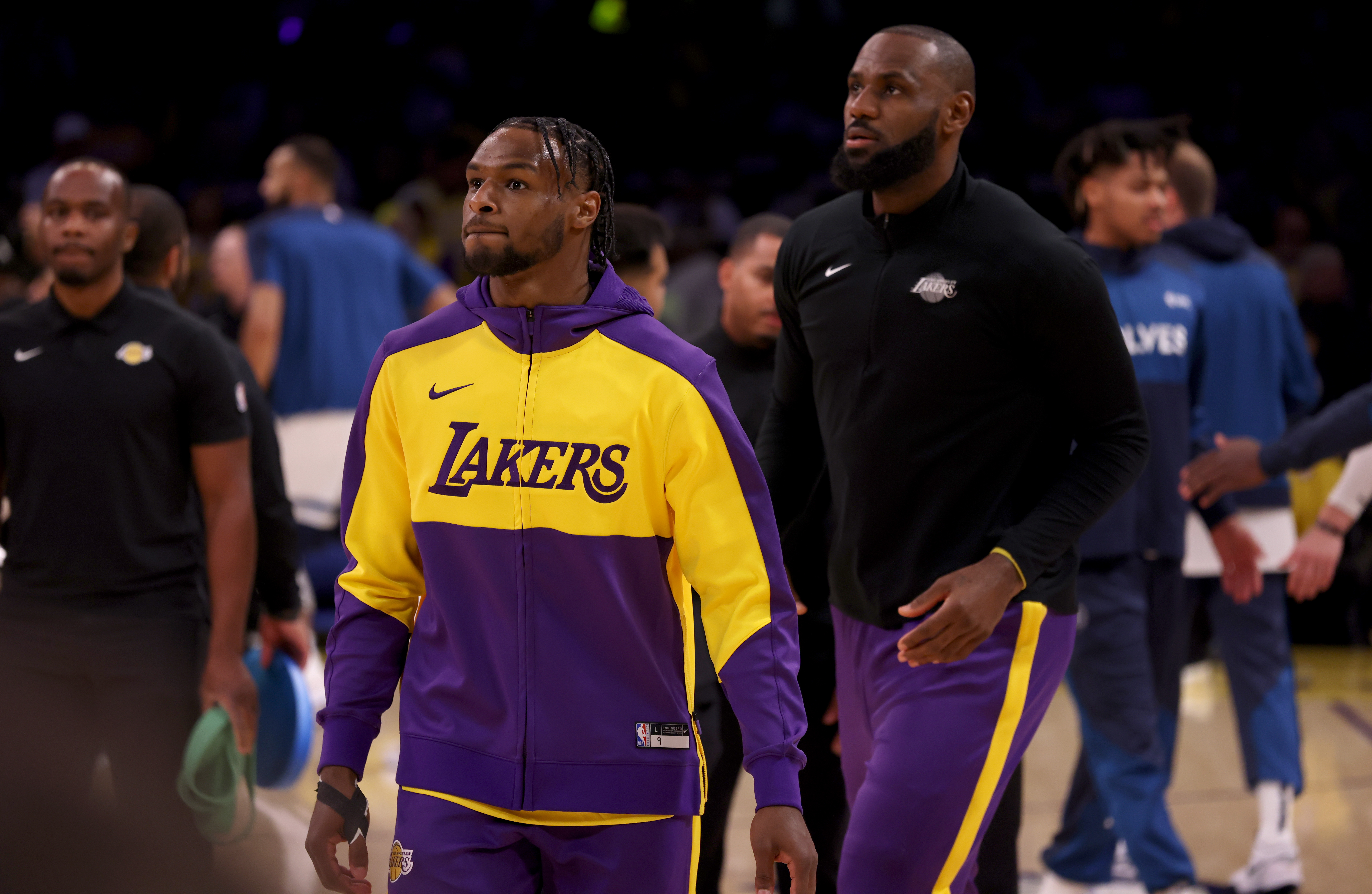 Oct 22, 2024; Los Angeles, California, USA; Los Angeles Lakers guard Bronny James (9) and forward LeBron James (23) warm up before a game against the Minnesota Timberwolves at Crypto.com Arena. Mandatory Credit: Jason Parkhurst-Imagn Images