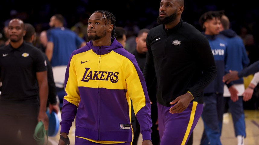 Oct 22, 2024; Los Angeles, California, USA; Los Angeles Lakers guard Bronny James (9) and forward LeBron James (23) warm up before a game against the Minnesota Timberwolves at Crypto.com Arena. Mandatory Credit: Jason Parkhurst-Imagn Images