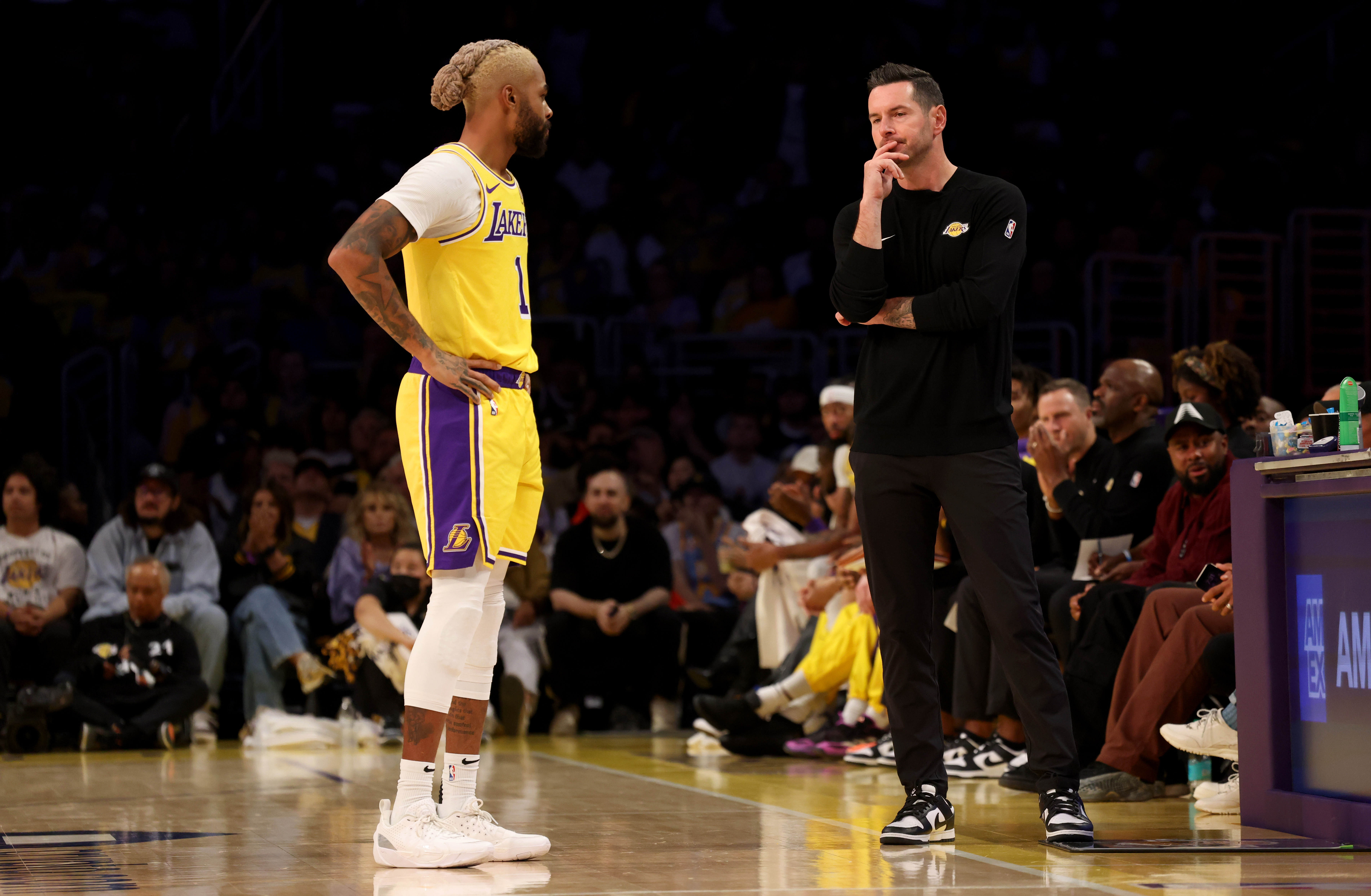 Oct 22, 2024; Los Angeles, California, USA; Los Angeles Lakers guard D'Angelo Russell (1) talks with head coach JJ Redick during the first quarter against the Minnesota Timberwolves at Crypto.com Arena. Mandatory Credit: Jason Parkhurst-Imagn Images