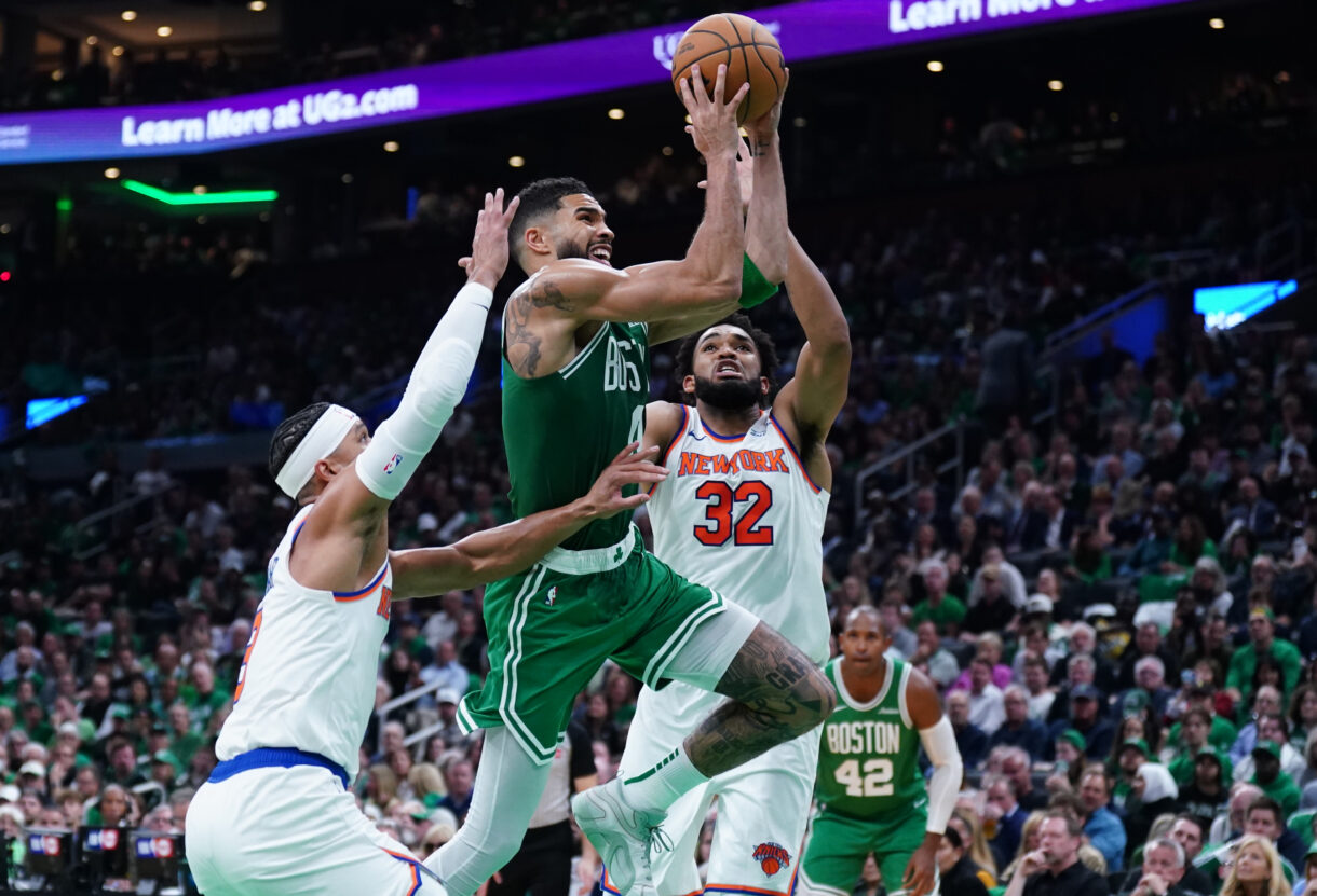 Oct 22, 2024; Boston, Massachusetts, USA; Boston Celtics forward Jayson Tatum (0) drives to the basket against New York Knicks center Karl-Anthony Towns (32) in the second quarter at TD Garden. Mandatory Credit: David Butler II-Imagn Images