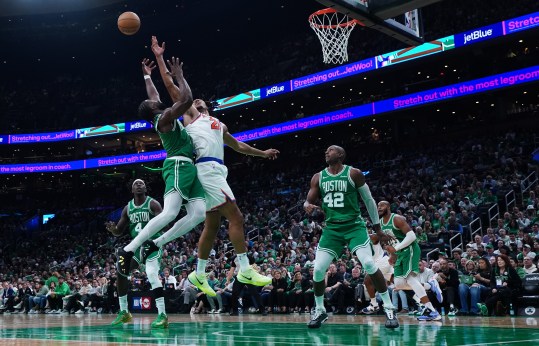 Oct 22, 2024; Boston, Massachusetts, USA; New York Knicks center Jericho Sims (20) and Boston Celtics guard Jaylen Brown (7) work for the ball in the second half at TD Garden. Mandatory Credit: David Butler II-Imagn Images