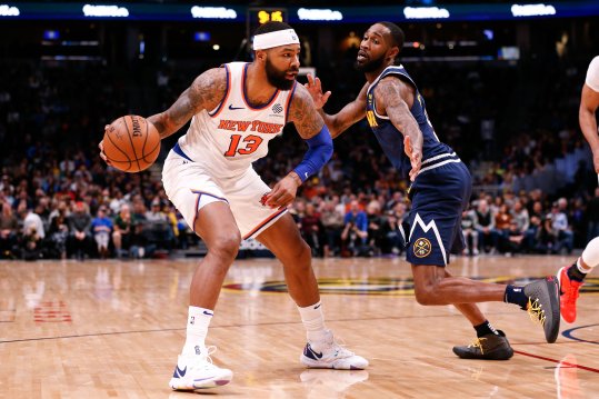 Dec 15, 2019; Denver, CO, USA; New York Knicks forward Marcus Morris Sr. (13) controls the ball as Denver Nuggets guard Will Barton III (5) defends in the third quarter at the Pepsi Center. Mandatory Credit: Isaiah J. Downing-Imagn Images