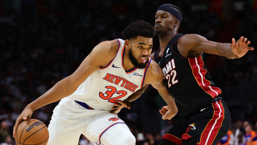 Oct 30, 2024; Miami, Florida, USA; New York Knicks center Karl-Anthony Towns (32) drives to the basketball against Miami Heat forward Jimmy Butler (22) during the fourth quarter at Kaseya Center. Mandatory Credit: Sam Navarro-Imagn Images