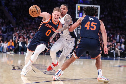 Mar 8, 2024; New York, New York, USA;  New York Knicks center Jericho Sims (45) sets a pick on Orlando Magic guard Markelle Fultz (20) as New York Knicks guard Donte DiVincenzo (0) drives to the basket in the fourth quarter at Madison Square Garden. Mandatory Credit: Wendell Cruz-Imagn Images