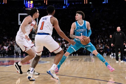 Oct 15, 2024; New York, New York, USA; Charlotte Hornets guard LaMelo Ball (1) sets the play as New York Knicks guard Pacome Dadiet (4) and New York Knicks guard Cameron Payne (1) defend during the second half at Madison Square Garden. Mandatory Credit: John Jones-Imagn Images