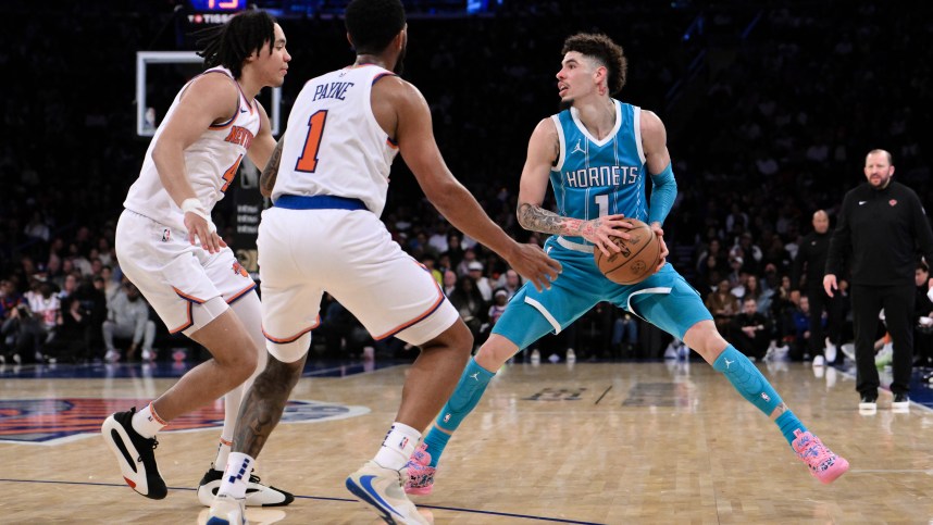 Oct 15, 2024; New York, New York, USA; Charlotte Hornets guard LaMelo Ball (1) sets the play as New York Knicks guard Pacome Dadiet (4) and New York Knicks guard Cameron Payne (1) defend during the second half at Madison Square Garden. Mandatory Credit: John Jones-Imagn Images