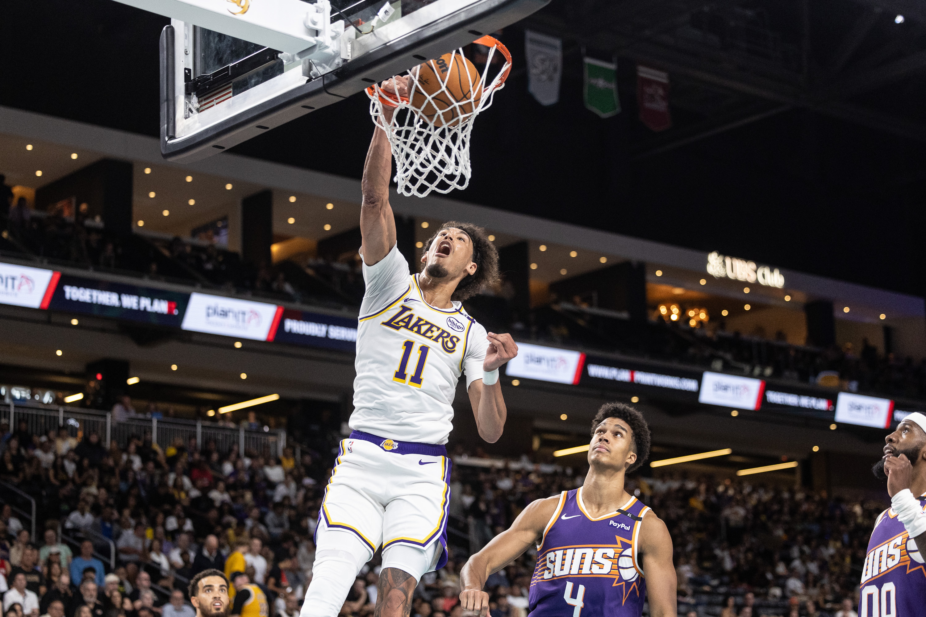 Oct 6, 2024; Palm Desert, California, USA; Los Angeles Lakers center Jaxson Hayes (11) dunks over Phoenix Suns center Oso Ighodaro (4) during the second half at Acrisure Arena. Mandatory Credit: David Frerker-Imagn Images