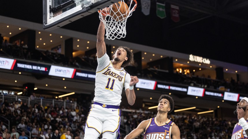 Oct 6, 2024; Palm Desert, California, USA; Los Angeles Lakers center Jaxson Hayes (11) dunks over Phoenix Suns center Oso Ighodaro (4) during the second half at Acrisure Arena. Mandatory Credit: David Frerker-Imagn Images