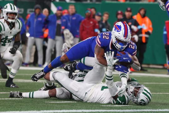 Oct 14, 2024; East Rutherford, New Jersey, USA; Buffalo Bills running back Ray Davis (22) runs with the ball while New York Jets cornerback Sauce Gardner (1) attempts to tackle him during the first half at MetLife Stadium. Mandatory Credit: Ed Mulholland-Imagn Images