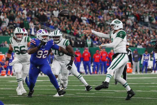 Oct 14, 2024; East Rutherford, New Jersey, USA; New York Jets quarterback Aaron Rodgers (8) throws a touchdown pass against the Buffalo Bills during the first half at MetLife Stadium. Mandatory Credit: Ed Mulholland-Imagn Images